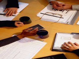 staff gather at table